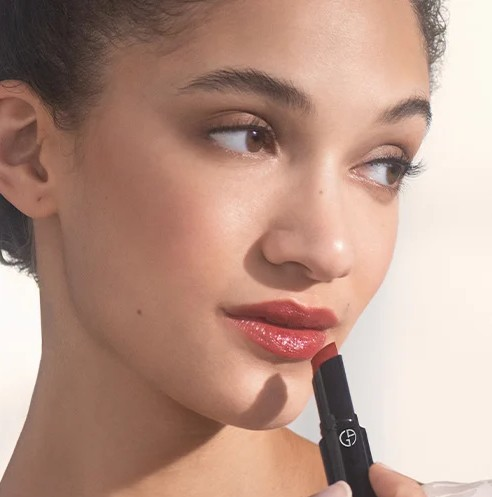 Flaconi - Frau trägt Lippenstift auf